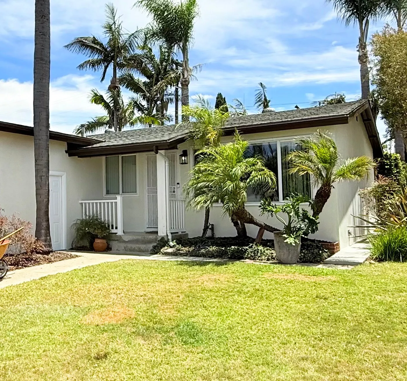 Single-story San Diego home with freshly painted stucco exterior and dark trim
